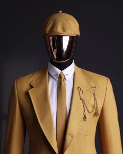 A Mustard Yellow Linen Jacket, Slim Cut Tie, Gurkha Pant Trousers, And Hat