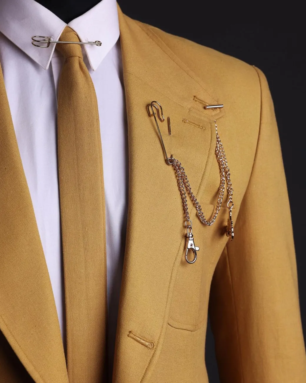 A Mustard Yellow Linen Jacket, Slim Cut Tie, Gurkha Pant Trousers, And Hat