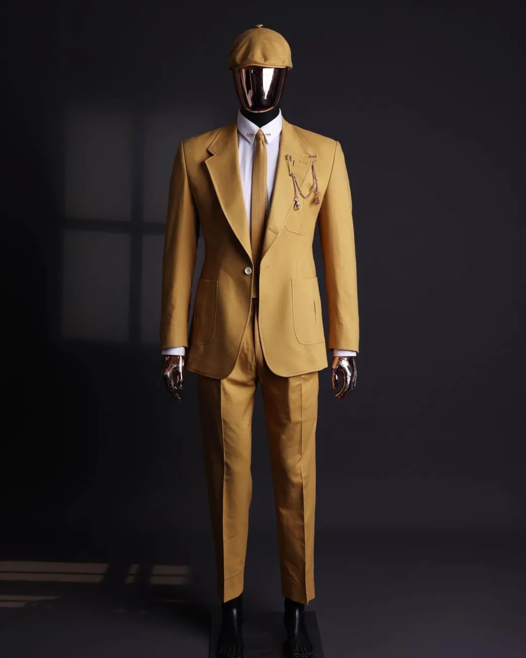 A Mustard Yellow Linen Jacket, Slim Cut Tie, Gurkha Pant Trousers, And Hat