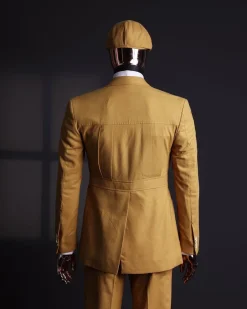 A Mustard Yellow Linen Jacket, Slim Cut Tie, Gurkha Pant Trousers, And Hat