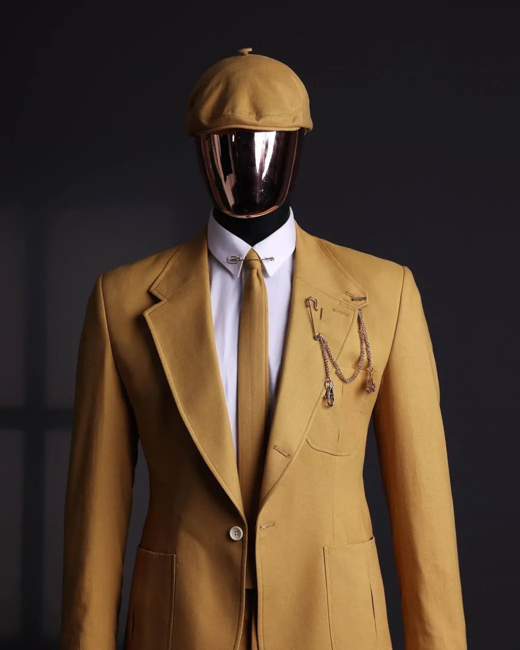 A Mustard Yellow Linen Jacket, Slim Cut Tie, Gurkha Pant Trousers, And Hat