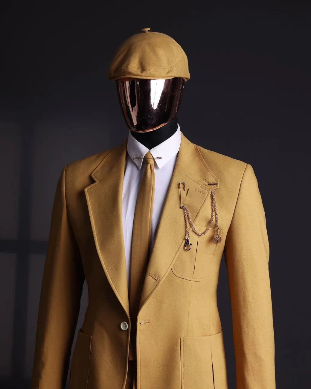 A Mustard Yellow Linen Jacket, Slim Cut Tie, Gurkha Pant Trousers, And Hat