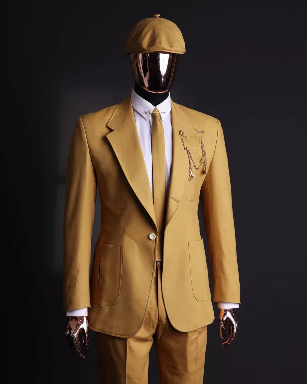 A Mustard Yellow Linen Jacket, Slim Cut Tie, Gurkha Pant Trousers, And Hat