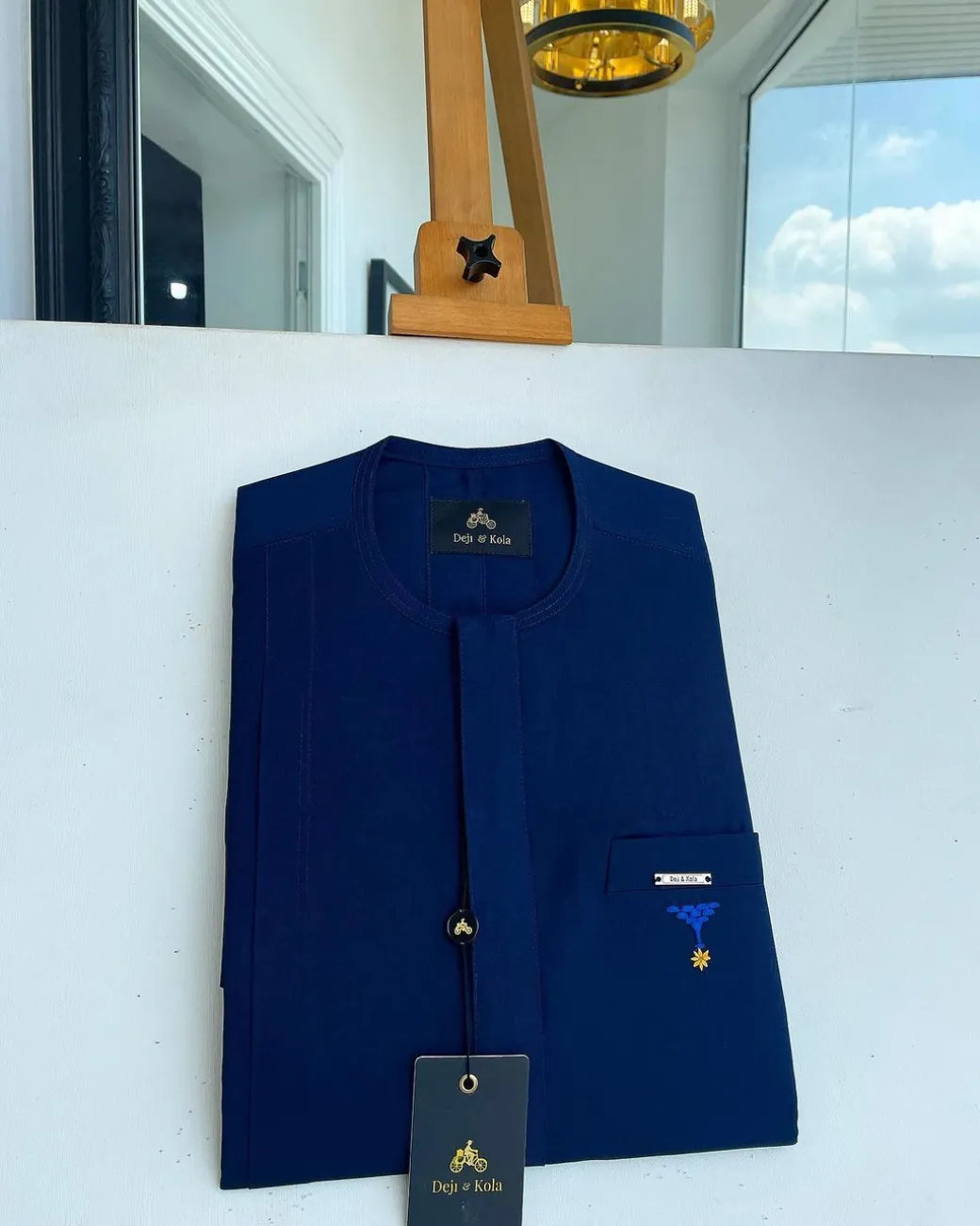 A Navy blue, front flap and slant pocket with inverted tree detailing senator kaftan native.