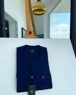 A Navy blue front flap and red lane pocket detail Senator Kaftan native