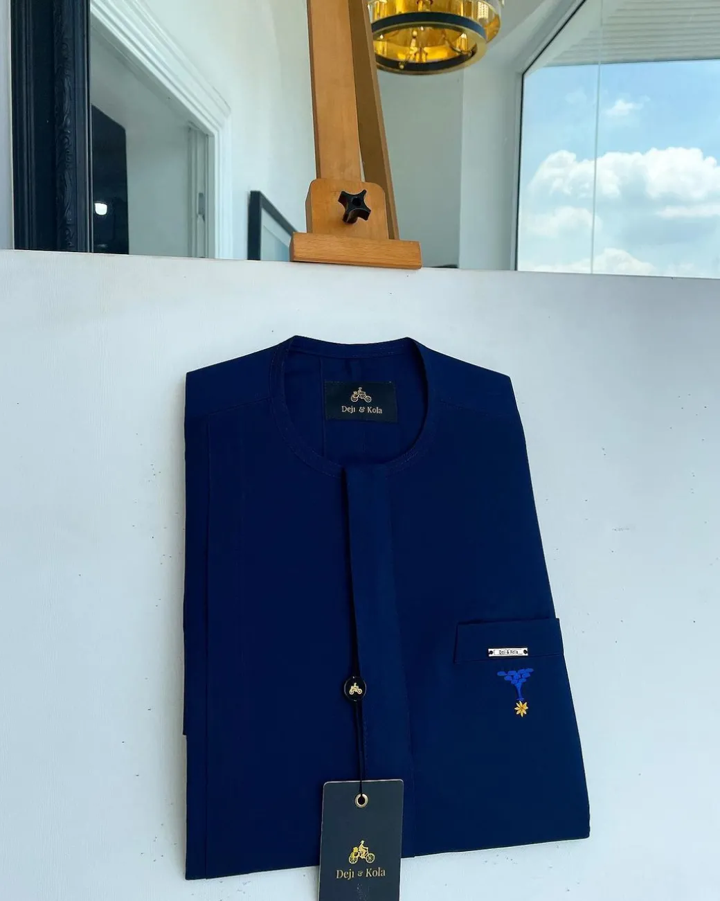 A Navy blue, front flap and slant pocket with inverted tree detailing senator kaftan native.