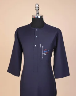 A navy blue, front flap with crystal blue Swarovski button, arrow and floral embroidery 3/4 sleeve African senator kaftan native.