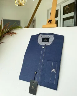 A navy blue kaftan with an interlocking patch pocket design.
