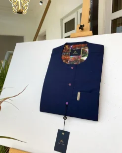 A Navy blue kaftan with purple paisley detailing, matching Swarovski button and sokoto