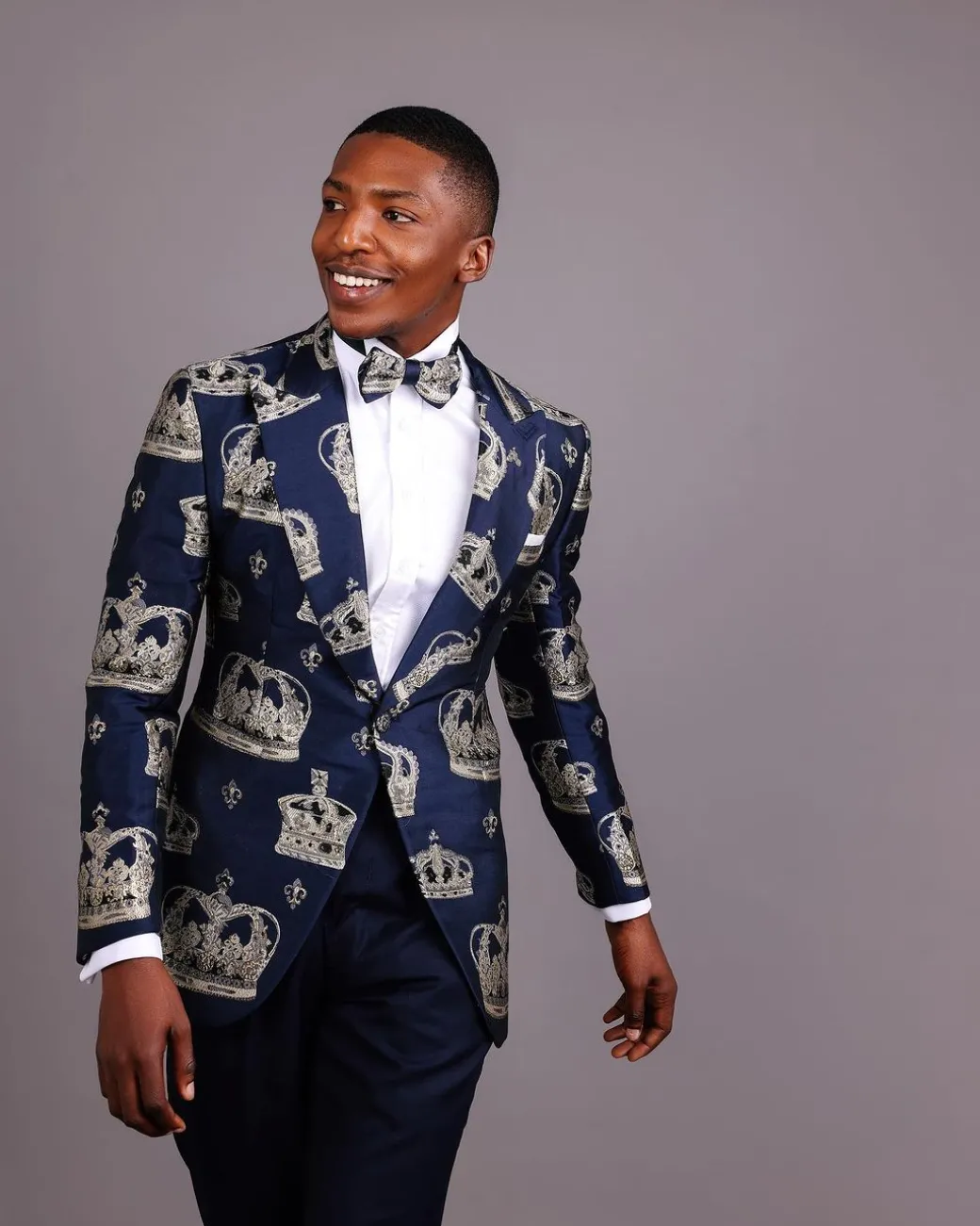 A Navy Blue Peak Lapel, Dispersed Crown Metallic Jacquard Tuxedo Suit And Wide Cut Pant Trouser.