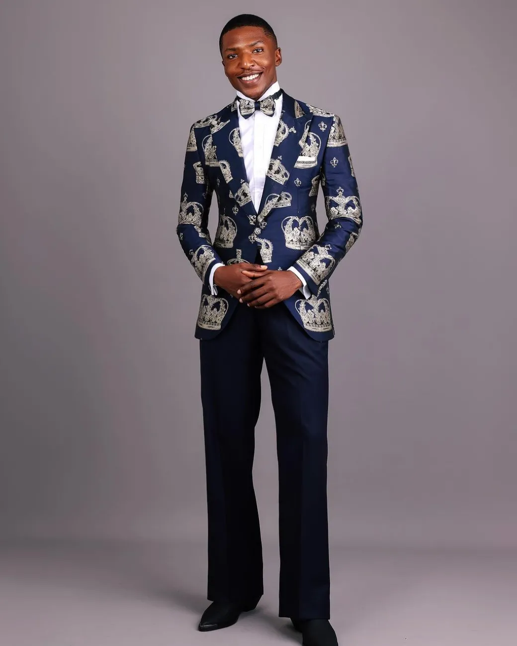 A Navy Blue Peak Lapel, Dispersed Crown Metallic Jacquard Tuxedo Suit And Wide Cut Pant Trouser.