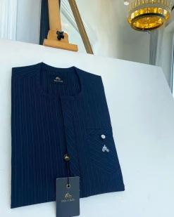 A Navy blue pencil stripe combat pocket with a clear view Swarovski silver button, front flap African kaftan native