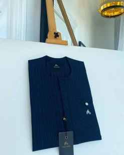 A Navy blue pencil stripe combat pocket with a clear view Swarovski silver button, front flap African kaftan native