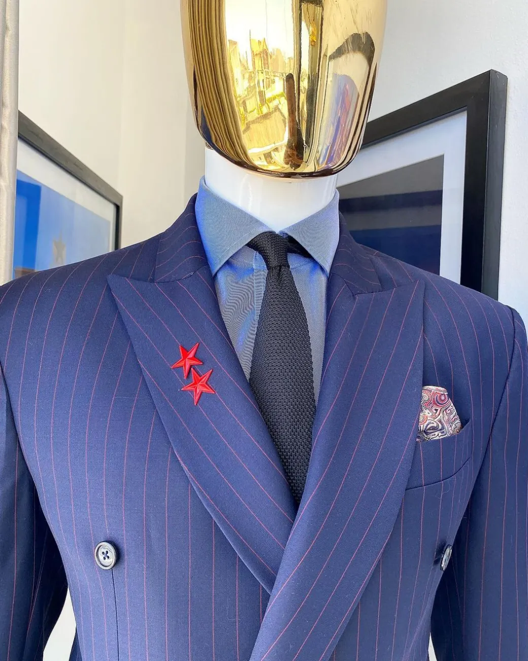 A Navy blue pinstripe double-breasted “Board Room” peak lapel suit