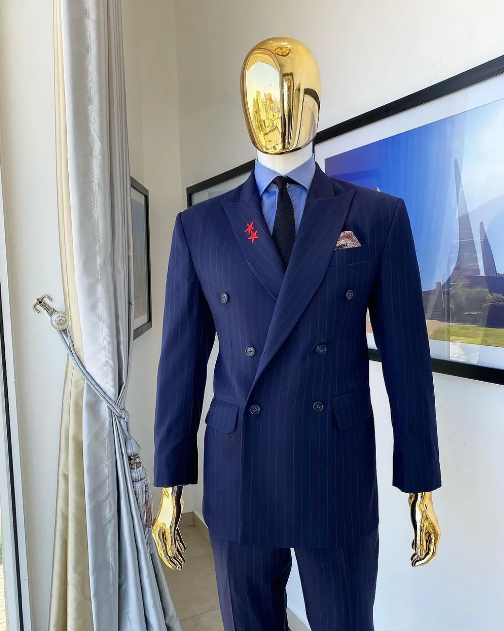 A Navy blue pinstripe double-breasted “Board Room” peak lapel suit