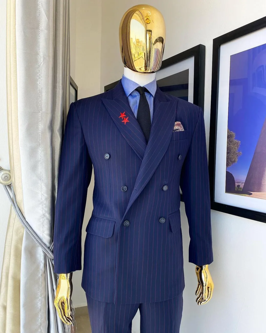 A Navy blue pinstripe double-breasted “Board Room” peak lapel suit