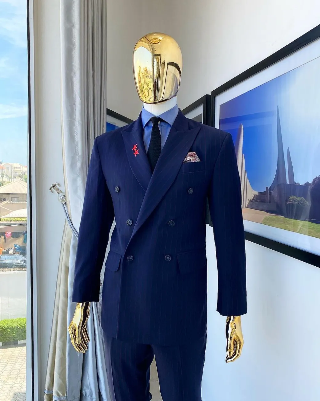 A Navy blue pinstripe double-breasted “Board Room” peak lapel suit