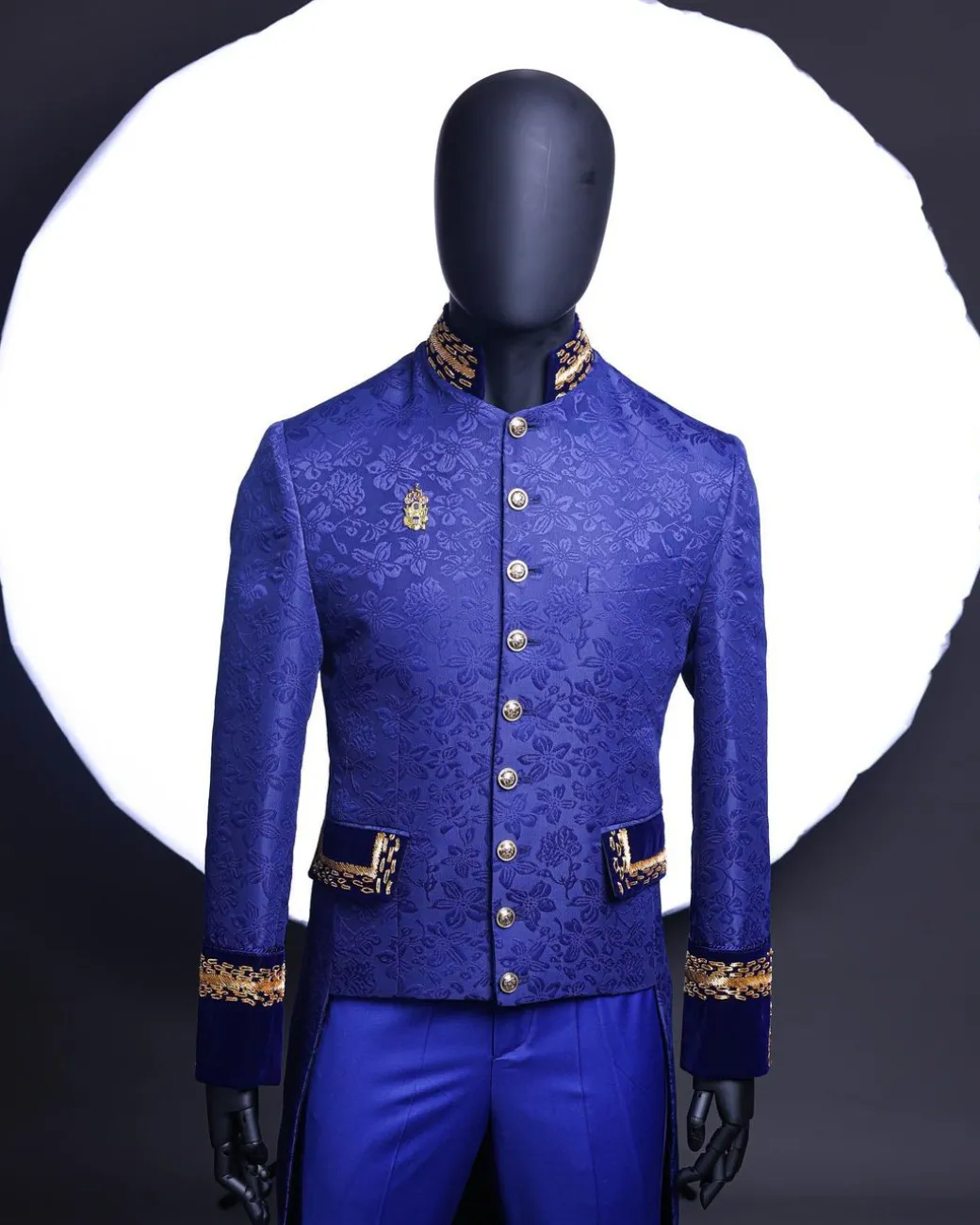 A Navy blue “Prince of Persia” ceremonial tail suit, Gold Metal Wire hand woven embroidery detail mix on velvet