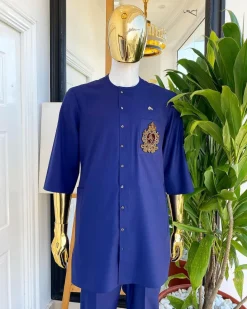 A navy blue “shirtan”, clear view jet black Swarovski button detailing, and hand-woven metal wire embroidery patch African traditional senator kaftan native