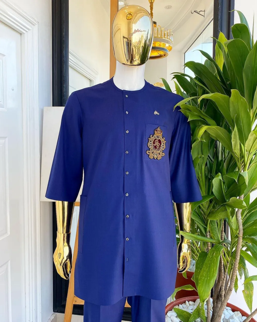 A navy blue “shirtan”, clear view jet black Swarovski button detailing, and hand-woven metal wire embroidery patch African traditional senator kaftan native