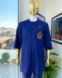 A navy blue “shirtan”, clear view jet black Swarovski button detailing, and hand-woven metal wire embroidery patch African traditional senator kaftan native
