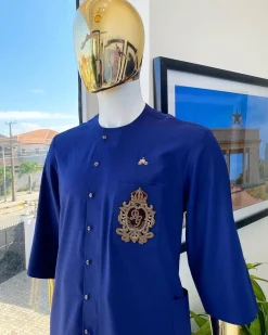 A navy blue “shirtan”, clear view jet black Swarovski button detailing, and hand-woven metal wire embroidery patch African traditional senator kaftan native