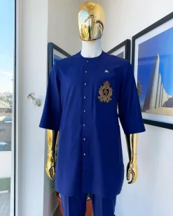 A navy blue “shirtan”, clear view jet black Swarovski button detailing, and hand-woven metal wire embroidery patch African traditional senator kaftan native