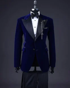 A Navy blue, soaked velvet peak lapel tuxedo suit