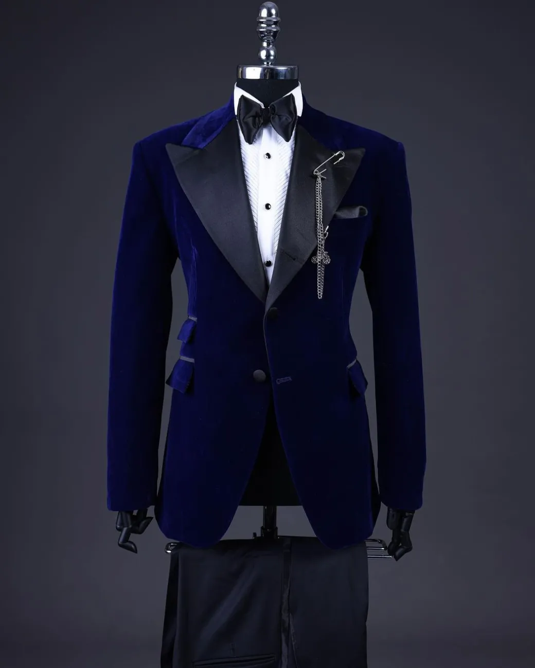 A Navy blue, soaked velvet peak lapel tuxedo suit