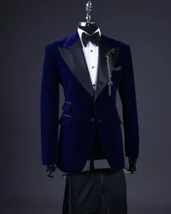 A Navy blue, soaked velvet peak lapel tuxedo suit
