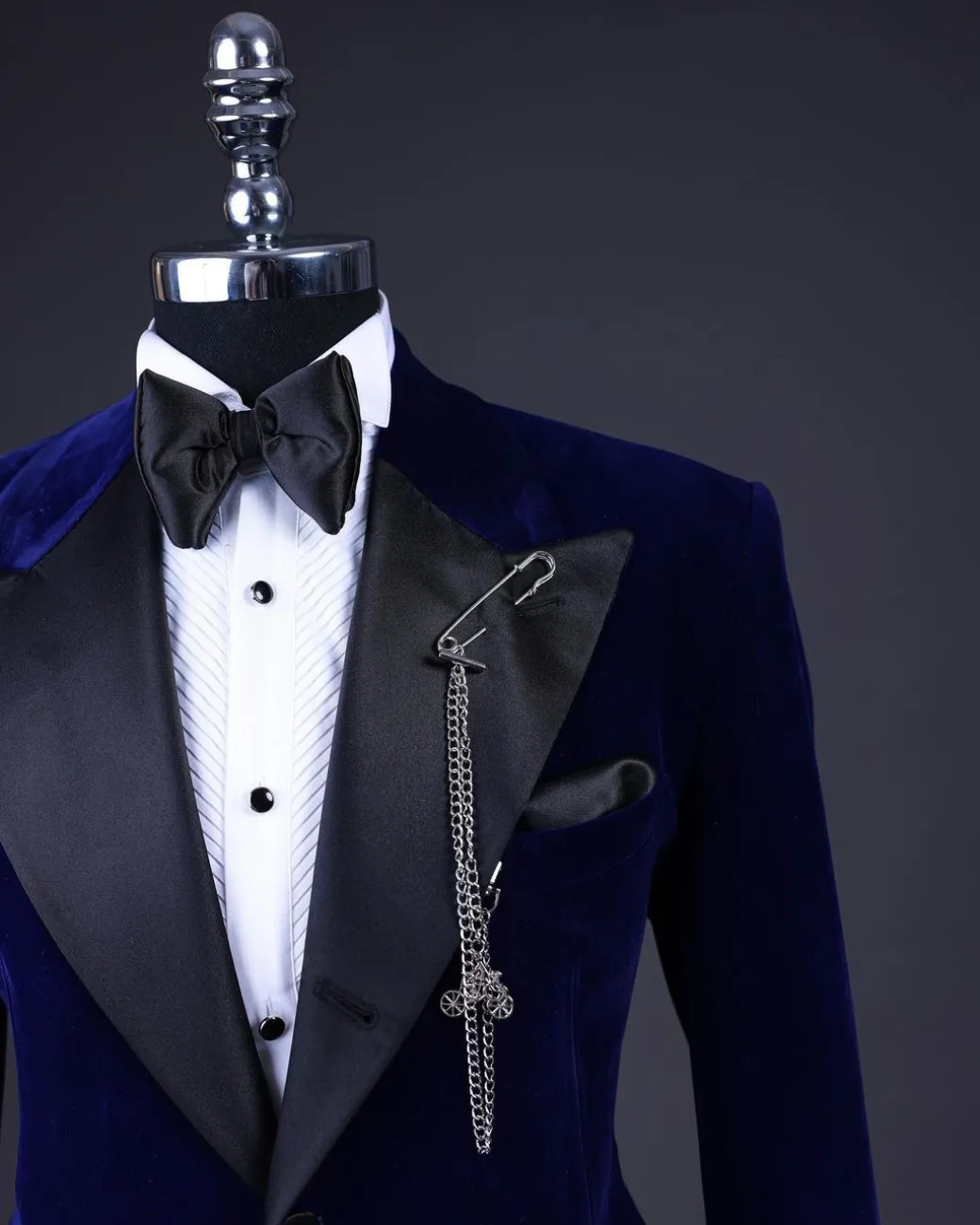 A Navy blue, soaked velvet peak lapel tuxedo suit