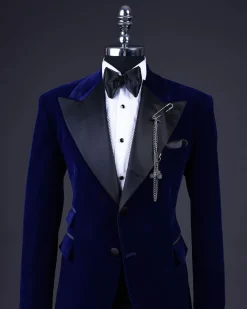 A Navy blue, soaked velvet peak lapel tuxedo suit
