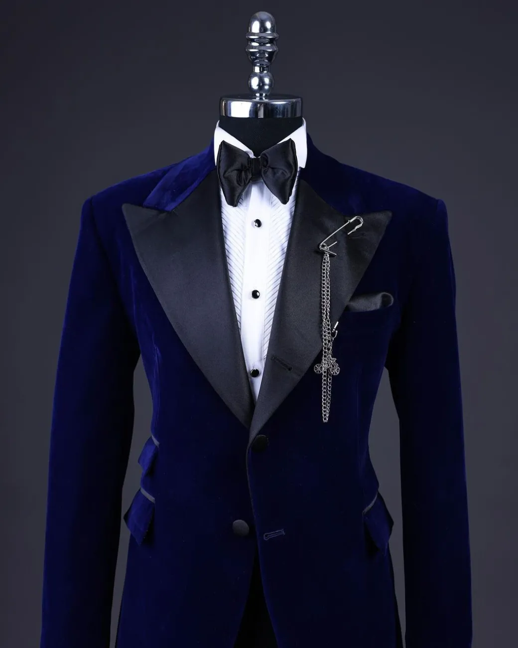 A Navy blue, soaked velvet peak lapel tuxedo suit