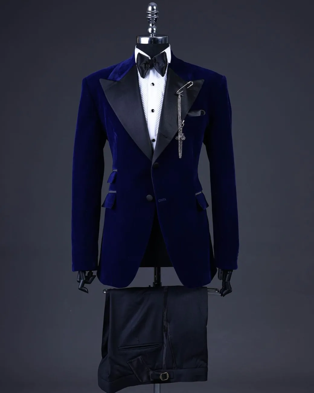 A Navy blue, soaked velvet peak lapel tuxedo suit