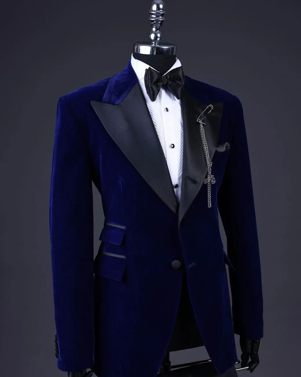 A Navy blue, soaked velvet peak lapel tuxedo suit