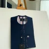 A Navy blue, sport paisley detailing flap and patch pocket and dotted front flap African traditional senator kaftan native.