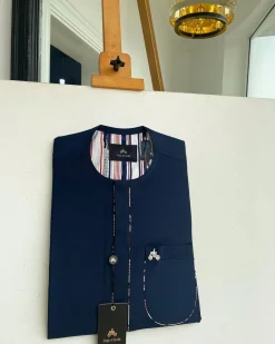 A Navy blue, sport paisley detailing flap and patch pocket and dotted front flap African traditional senator kaftan native.