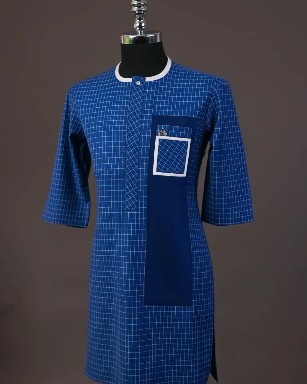 A Neon blue, graph check, front flap with Swarovski button details, and layered pocket traditional senator kaftan native