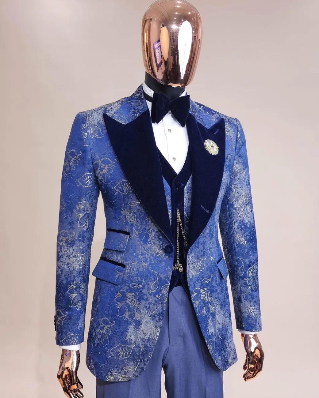A peak lapel dispersed Sky blue and splashed champagne gold metallic jacquard tuxedo suit