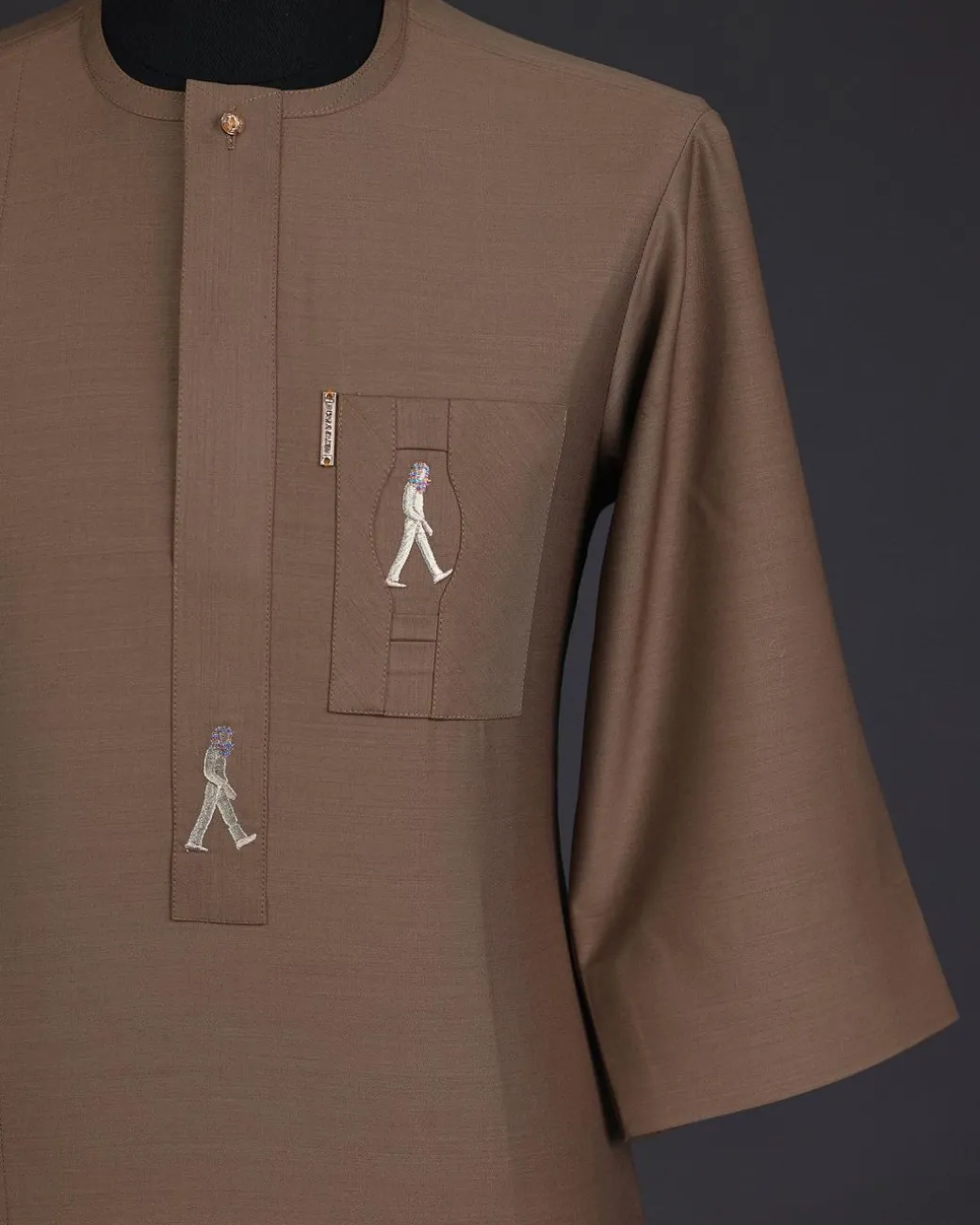A Peanut brown, front flap, walking paul embroidery details, 3/4 sleeve African senator kaftan native.