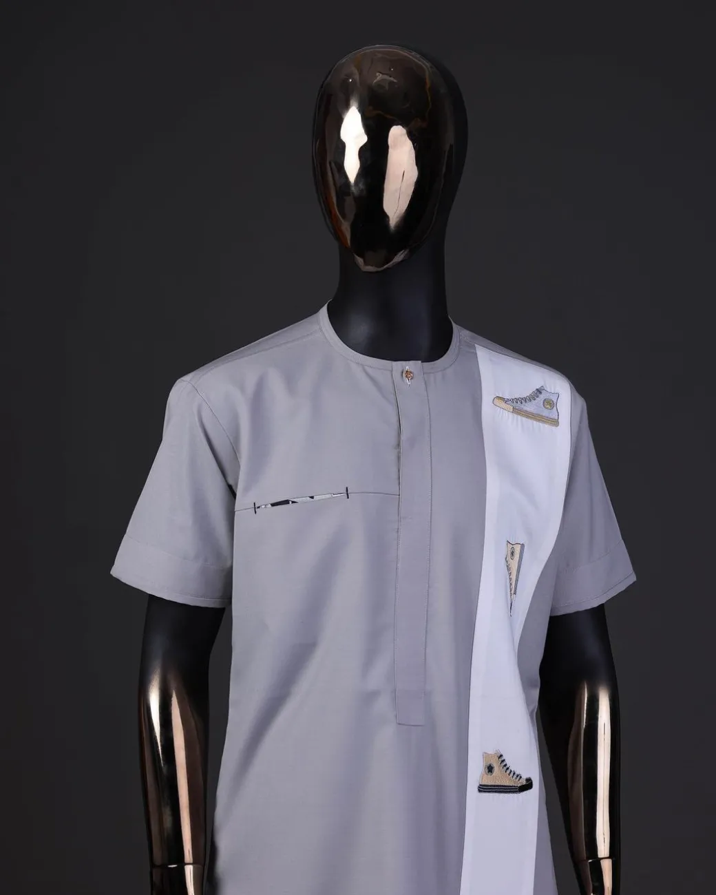 A pewter grey front flap with gold Swarovski button detailing and side all-stars embroidery detailing on white kaftan and Sokoto