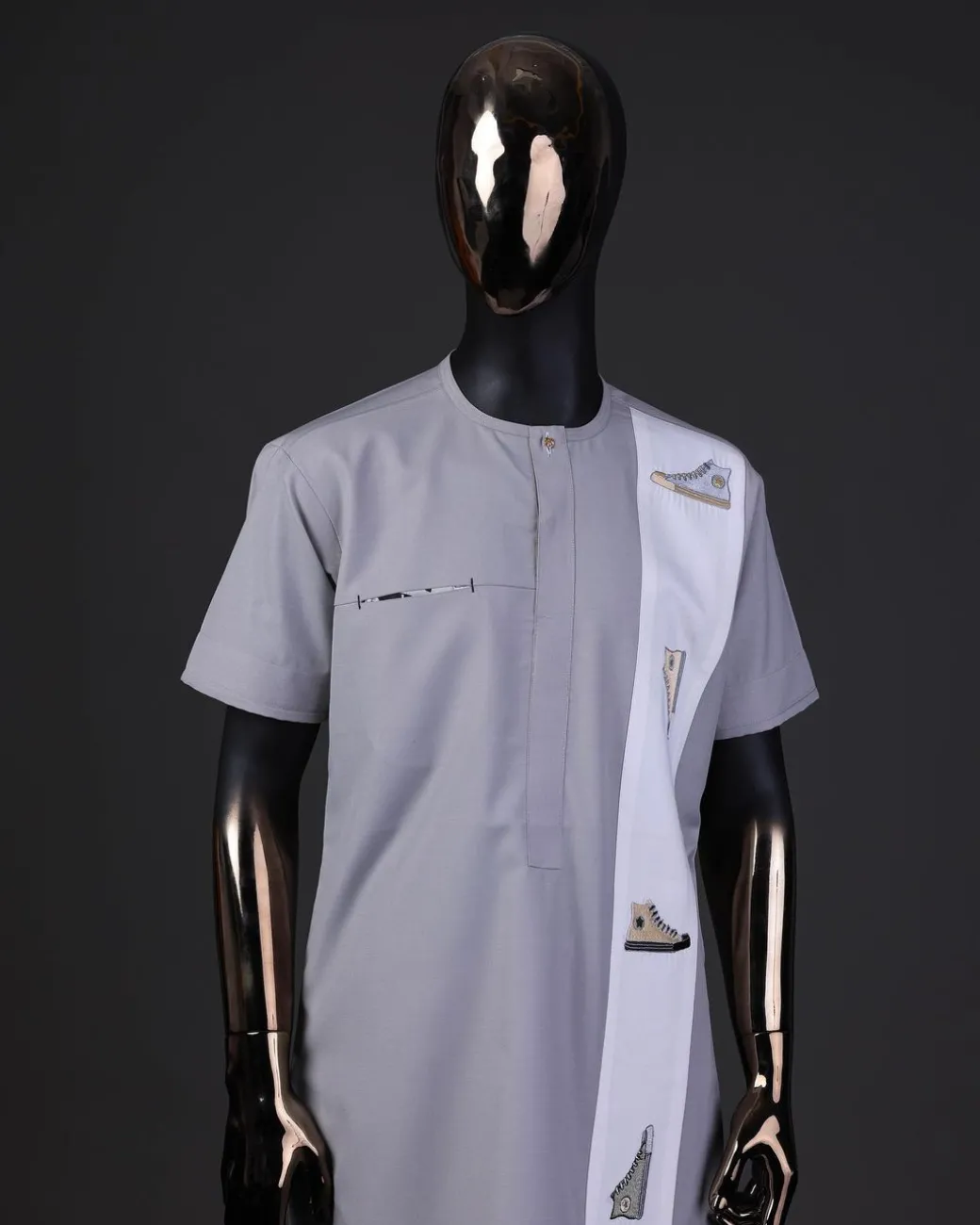 A pewter grey front flap with gold Swarovski button detailing and side all-stars embroidery detailing on white kaftan and Sokoto