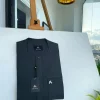 A Phthalo green, front flap and patch pocket with black Swarovski button detailing senator kaftan native.