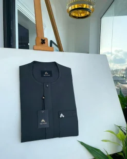 A Phthalo green, front flap and patch pocket with black Swarovski button detailing senator kaftan native.