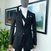 A “power” front and back slit charcoal black, long cross strap peak lapel suit
