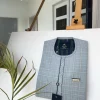 A Prince Charles check fabric kaftan with a cornerpiece flap design