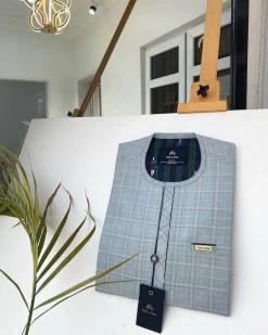 A Prince Charles check fabric kaftan with a cornerpiece flap design