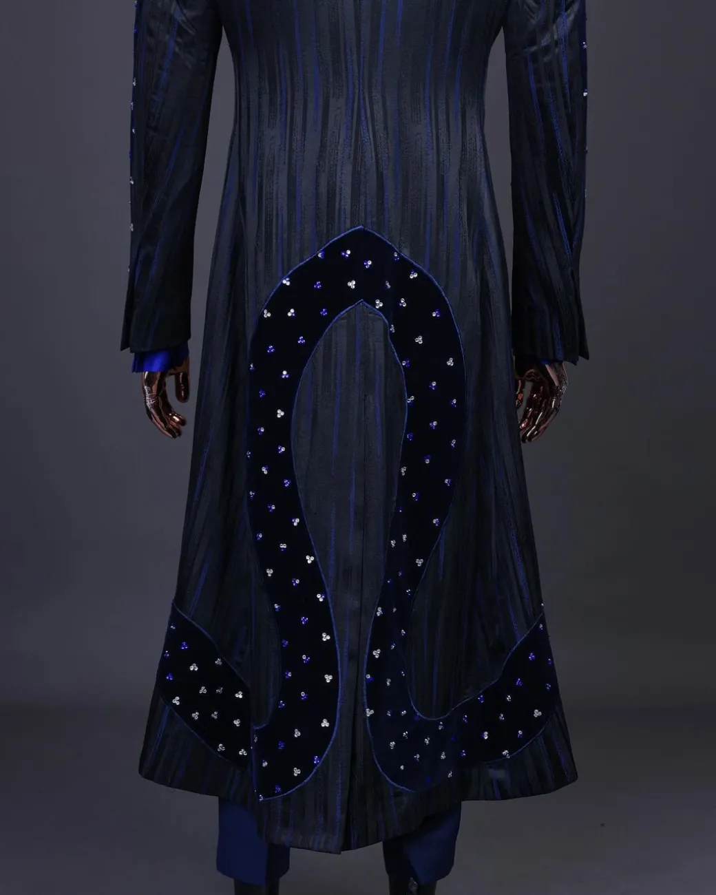 A “Prodigal” lashed midnight blue, admiral blue and splashed black metallic jacquard trench suit