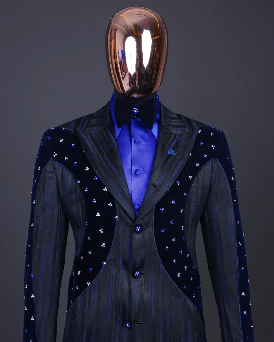 A “Prodigal” lashed midnight blue, admiral blue and splashed black metallic jacquard trench suit