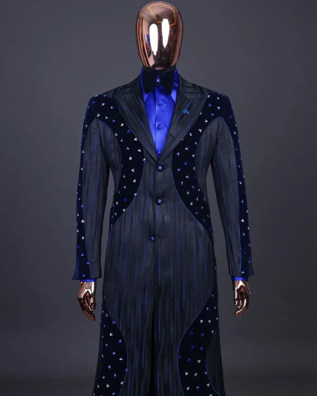 A “Prodigal” lashed midnight blue, admiral blue and splashed black metallic jacquard trench suit